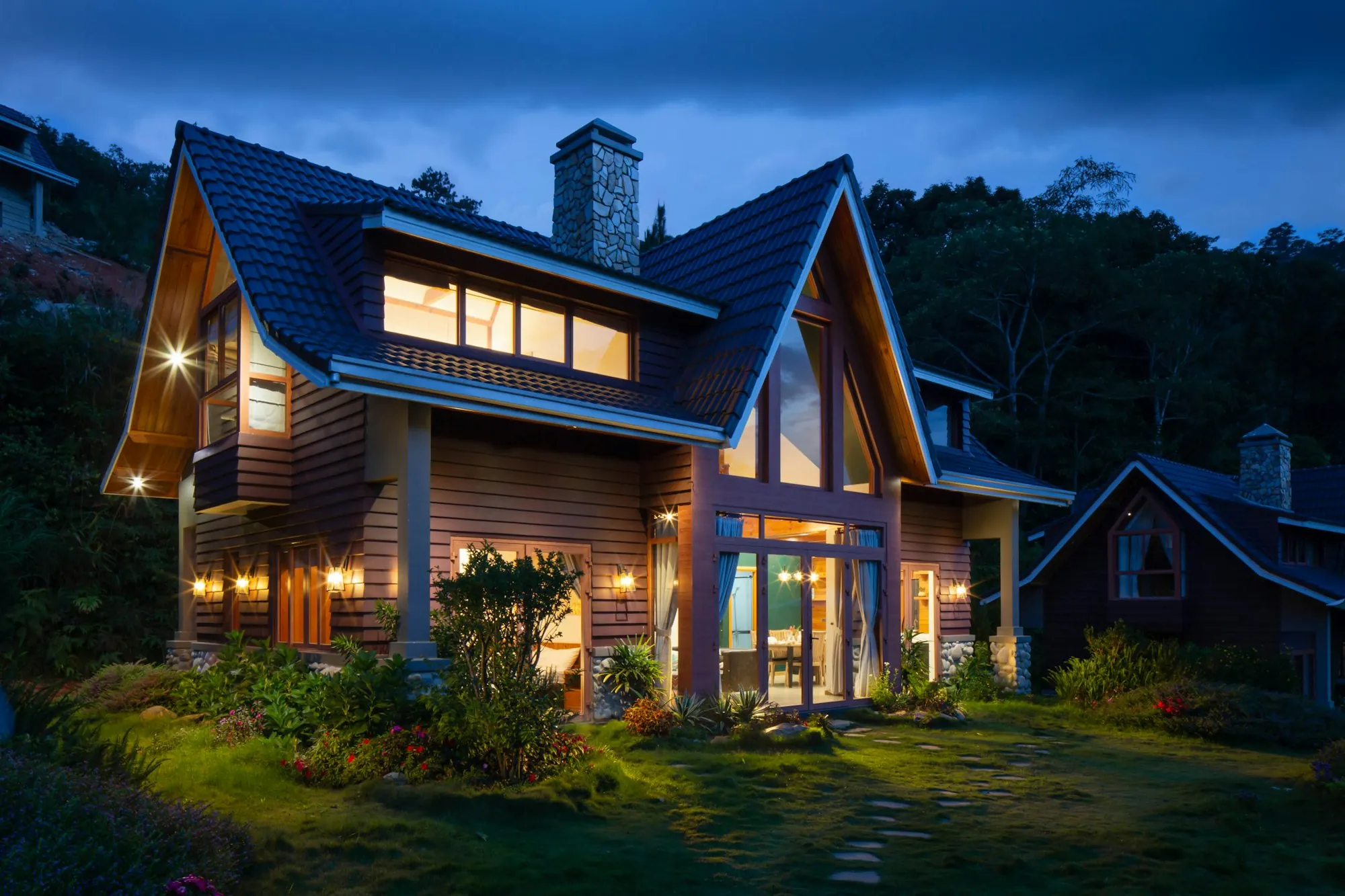 A warmly lit contemporary home glowing from within at dusk
