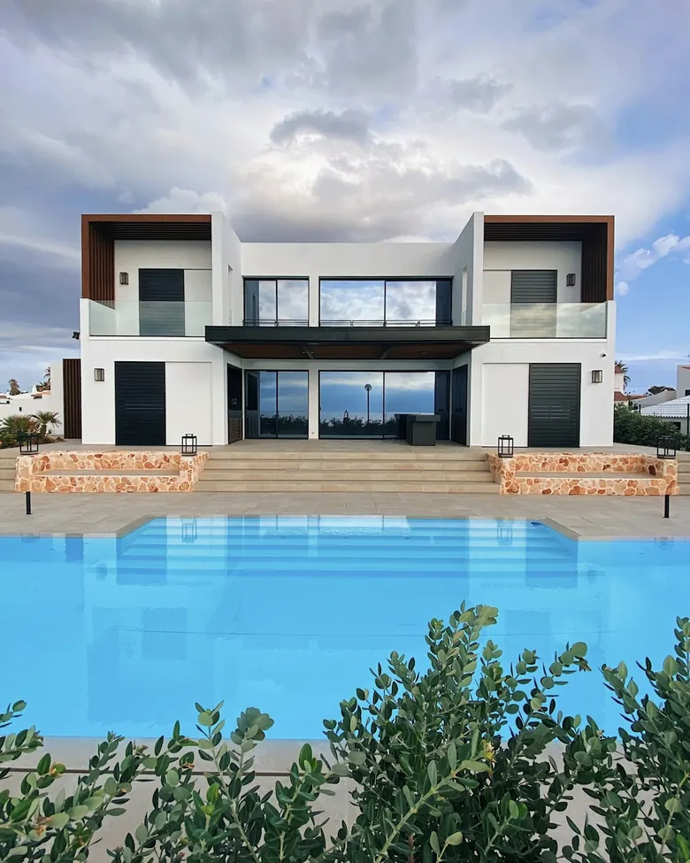 Poolside terrace of a white villa