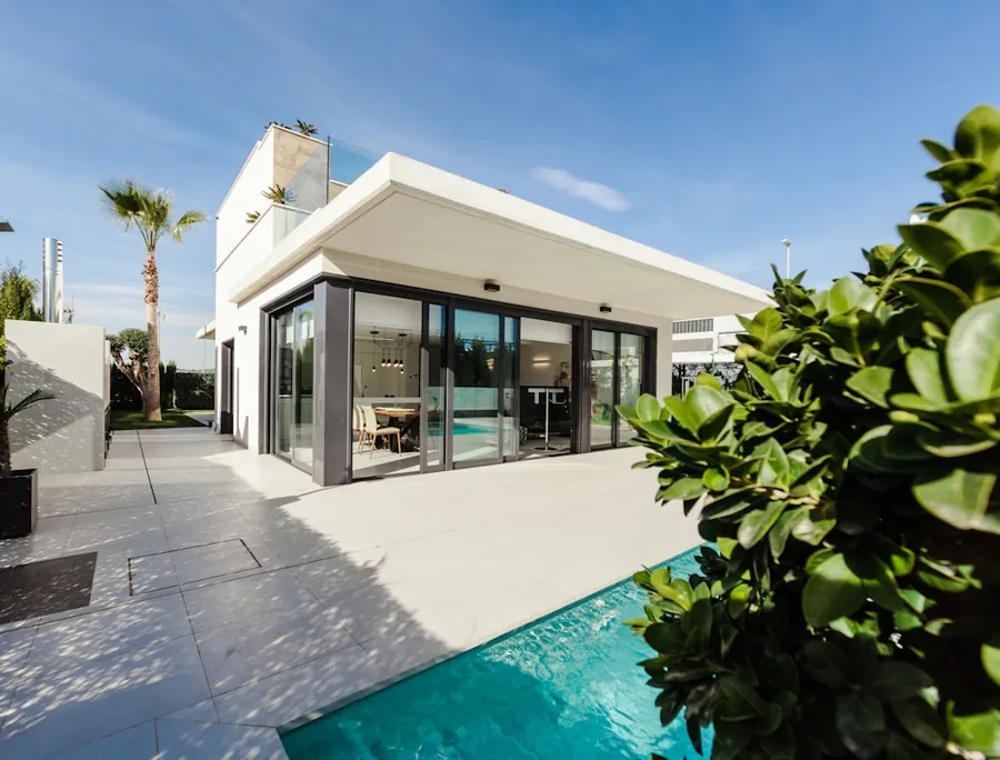 A modern Florida home with a pool framed by palms