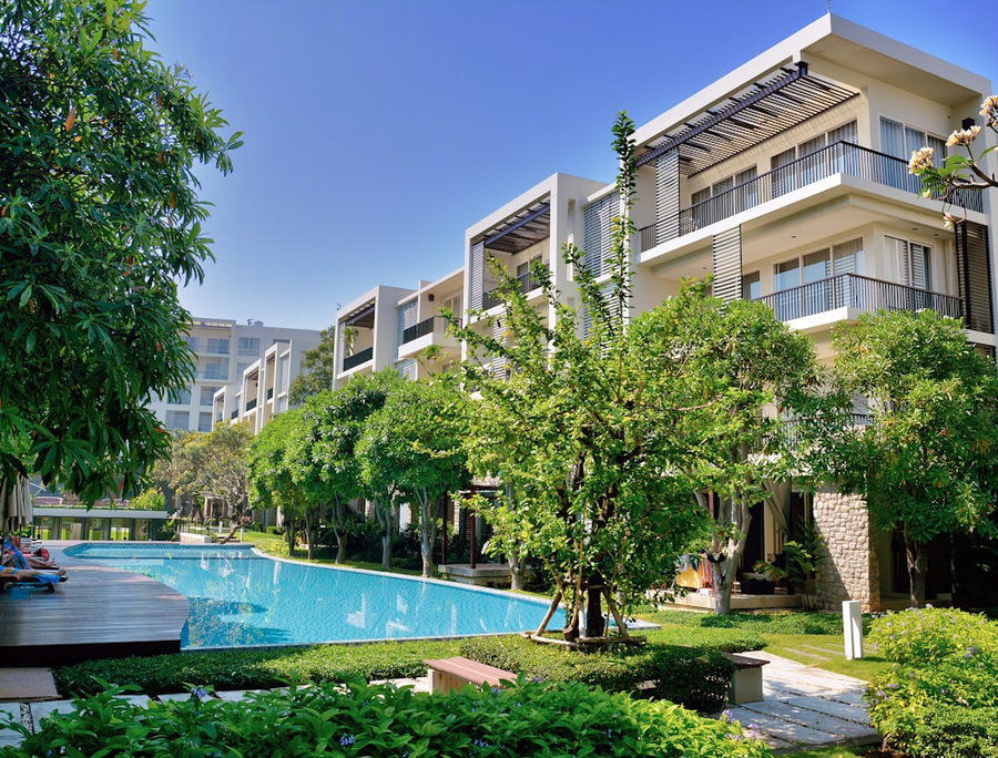 Terraced apartments above a landscaped pool