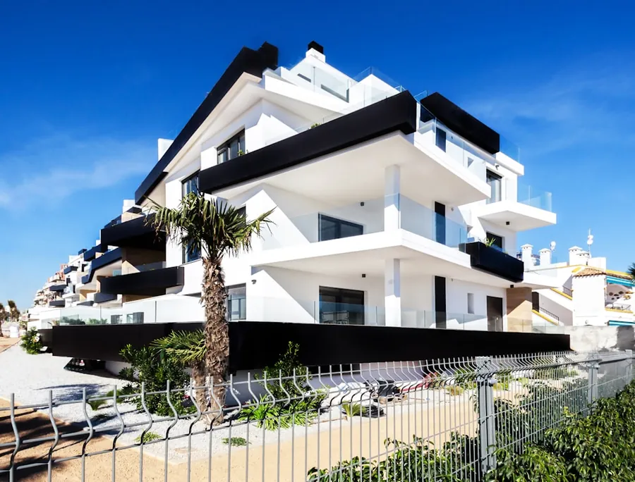Sculptural white apartment building against a blue sky